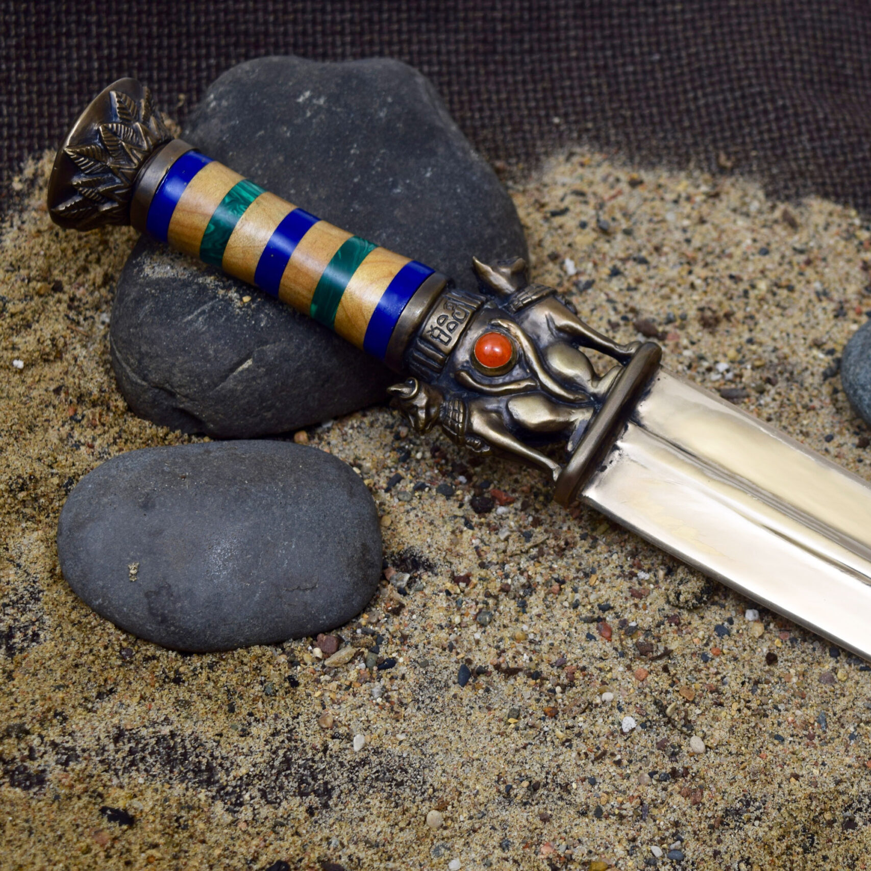 a double-edged knife with an egyptian motif